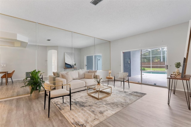 4110 Maplegrove Dr, Orlando, FL 32818 - living room with wood finished floors, arched walkways, and a textured ceiling