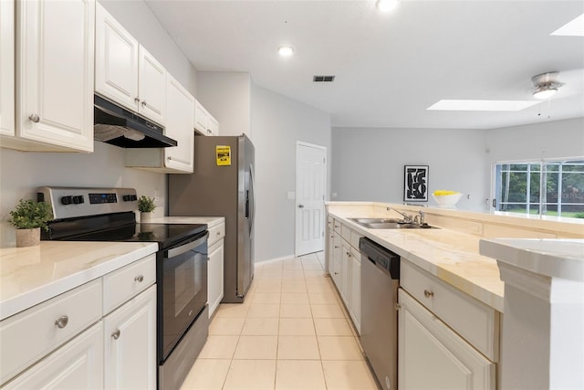 4110 Maplegrove Dr, Orlando, FL 32818 - kitchen with appliances with stainless steel finishes, under cabinet range hood, a skylight, light countertops, and white cabinetry