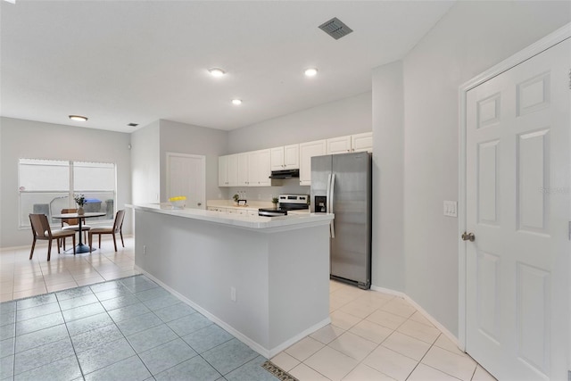 4110 Maplegrove Dr, Orlando, FL 32818 - kitchen featuring stainless steel appliances, under cabinet range hood, light countertops, white cabinetry, and light tile patterned floors