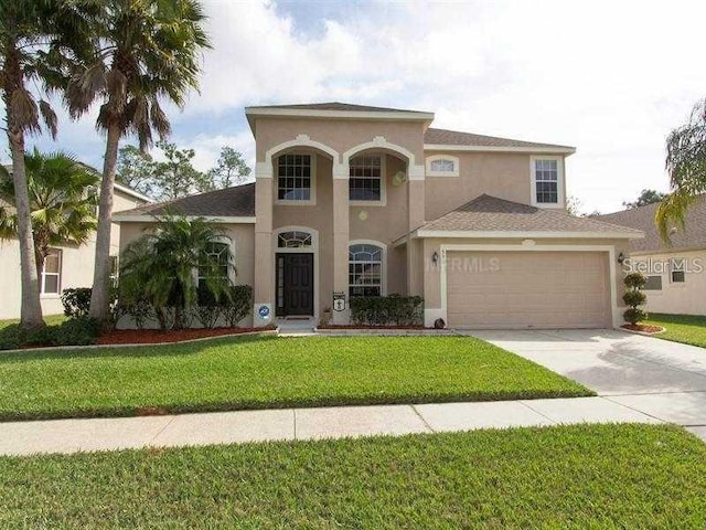 531 Canary Island Ct, Orlando, FL 32828 - mediterranean / spanish-style house with stucco siding, a garage, concrete driveway, and a front yard