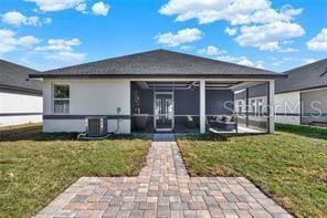 3507 W Jefferson St, Orlando, FL 32805 - rear view of house featuring a sunroom and a lawn