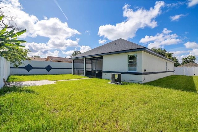 3507 W Jefferson St, Orlando, FL 32805 - rear view of house with a sunroom, a fenced backyard, and stucco siding