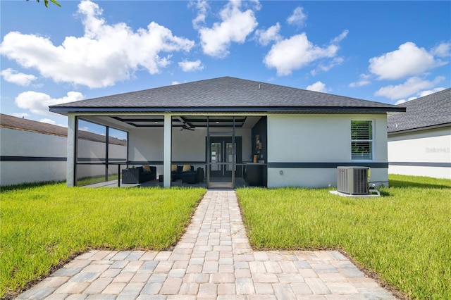 3507 W Jefferson St, Orlando, FL 32805 - rear view of property with ceiling fan, a yard, a sunroom, stucco siding, and outdoor lounge area