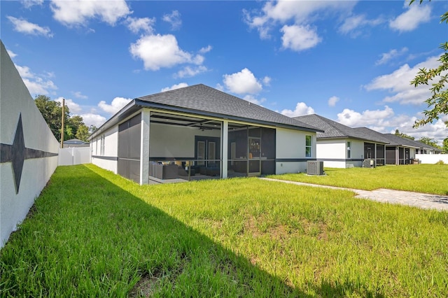 3507 W Jefferson St, Orlando, FL 32805 - back of property with a sunroom, a fenced backyard, stucco siding, roof with shingles, and ceiling fan