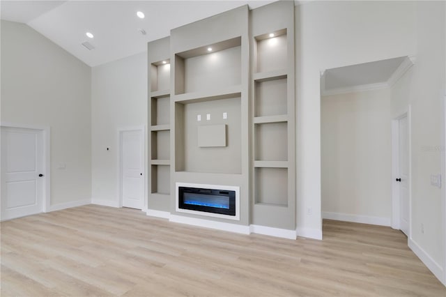 3507 W Jefferson St, Orlando, FL 32805 - unfurnished living room featuring built in shelves, light wood-type flooring, and a glass covered fireplace