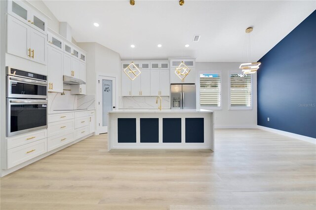 3507 W Jefferson St, Orlando, FL 32805 - kitchen featuring appliances with stainless steel finishes, light wood-style flooring, a kitchen island with sink, light countertops, and recessed lighting