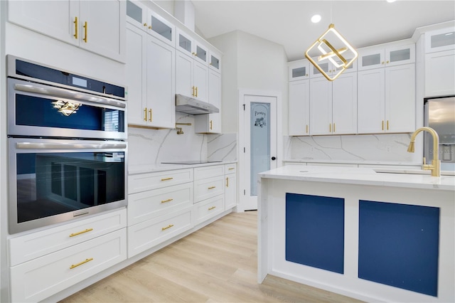 3507 W Jefferson St, Orlando, FL 32805 - kitchen featuring appliances with stainless steel finishes, decorative backsplash, light wood-style flooring, light stone counters, and recessed lighting