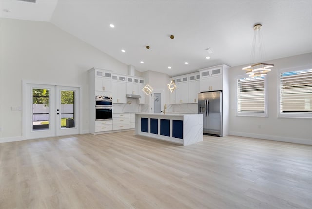 3507 W Jefferson St, Orlando, FL 32805 - kitchen with appliances with stainless steel finishes, open floor plan, an island with sink, light countertops, and recessed lighting