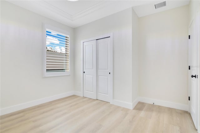 3507 W Jefferson St, Orlando, FL 32805 - unfurnished bedroom with wood finished floors and a closet