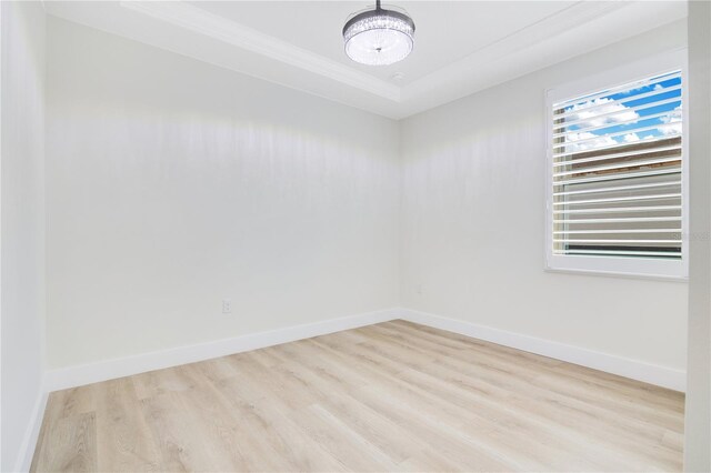 3507 W Jefferson St, Orlando, FL 32805 - spare room with a chandelier, wood finished floors, and crown molding