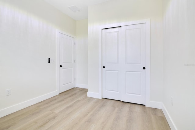 3507 W Jefferson St, Orlando, FL 32805 - unfurnished bedroom with light wood-style flooring and a closet
