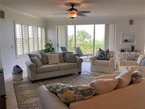 225 N Atlantic Ave Unit 205, Cocoa Beach, FL 32931 - living room featuring ornamental molding, ceiling fan, and tile patterned flooring