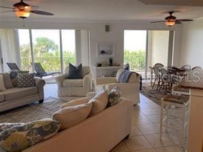 225 N Atlantic Ave Unit 205, Cocoa Beach, FL 32931 - living room featuring a ceiling fan, plenty of natural light, and light tile patterned flooring