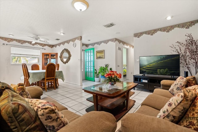 5324 Barefoot Path, Kissimmee, FL 34746 - living room featuring light tile patterned floors, a ceiling fan, and a textured ceiling