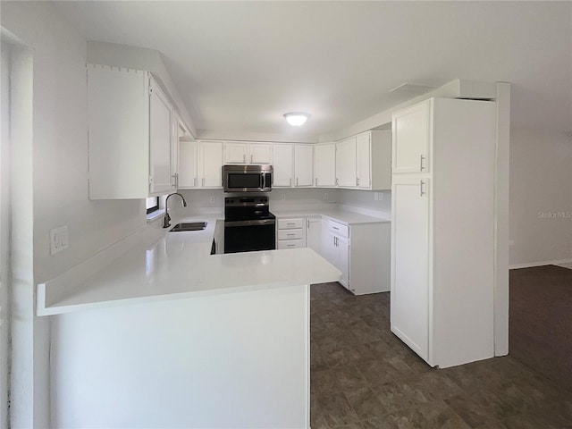2575 King Ave, Auburndale, FL 33823 - kitchen featuring stainless steel microwave, electric stove, a peninsula, light countertops, and white cabinets