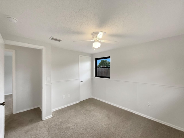 2575 King Ave, Auburndale, FL 33823 - unfurnished bedroom with carpet, a textured ceiling, and ceiling fan