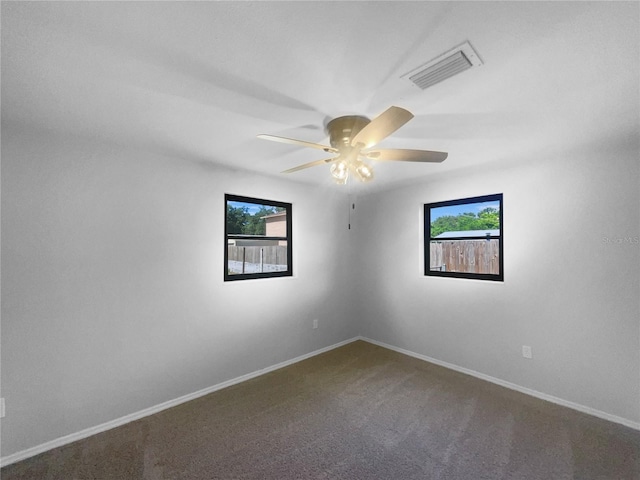 2575 King Ave, Auburndale, FL 33823 - empty room featuring plenty of natural light, carpet flooring, and a ceiling fan