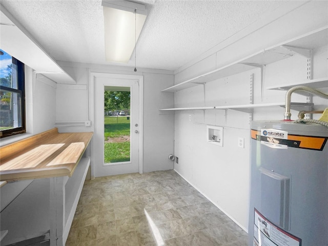 2575 King Ave, Auburndale, FL 33823 - laundry area featuring electric water heater, a textured ceiling, and washer hookup