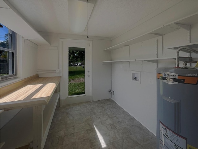 2575 King Ave, Auburndale, FL 33823 - laundry room with water heater, washer hookup, healthy amount of natural light, and a textured ceiling