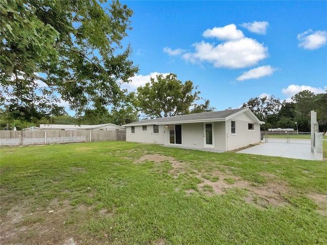2575 King Ave, Auburndale, FL 33823 - rear view of property featuring a fenced backyard, a patio, and stucco siding