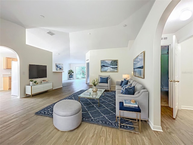 2353 Kingscrest Cir, Apopka, FL 32712 - living room with arched walkways, wood finished floors, and high vaulted ceiling