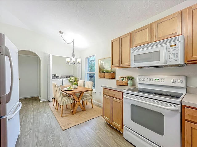 2353 Kingscrest Cir, Apopka, FL 32712 - kitchen featuring white appliances, light wood finished floors, a chandelier, light countertops, and separate washer and dryer