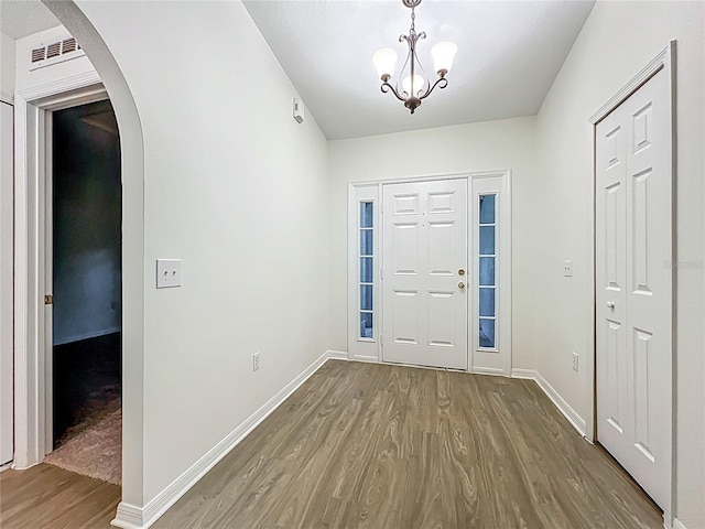 2353 Kingscrest Cir, Apopka, FL 32712 - entrance foyer with wood finished floors, arched walkways, and a chandelier