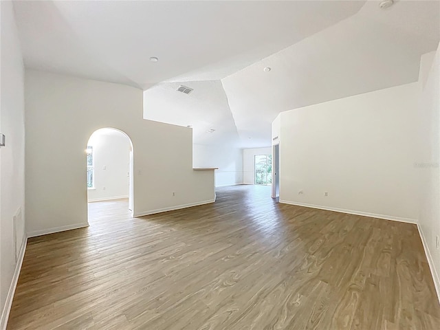 2353 Kingscrest Cir, Apopka, FL 32712 - spare room featuring arched walkways, wood finished floors, and high vaulted ceiling