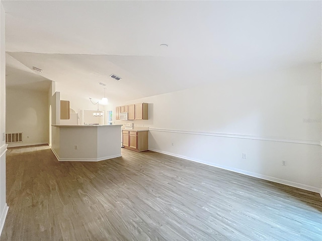 2353 Kingscrest Cir, Apopka, FL 32712 - unfurnished living room with light wood-style floors, vaulted ceiling, and a chandelier