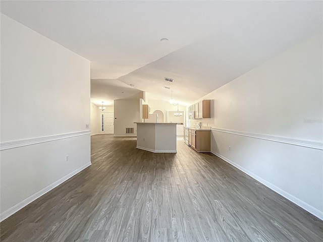 2353 Kingscrest Cir, Apopka, FL 32712 - unfurnished living room featuring dark wood-style floors, lofted ceiling, and a chandelier