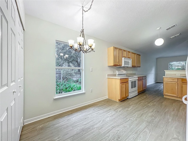 2353 Kingscrest Cir, Apopka, FL 32712 - kitchen featuring white appliances, light wood-type flooring, a chandelier, hanging light fixtures, and light countertops