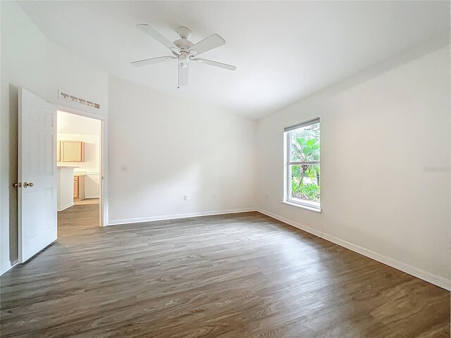 2353 Kingscrest Cir, Apopka, FL 32712 - empty room featuring lofted ceiling, wood finished floors, and a ceiling fan