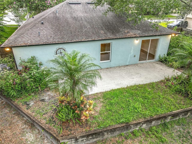 2353 Kingscrest Cir, Apopka, FL 32712 - back of house featuring a shingled roof, stucco siding, and a patio area