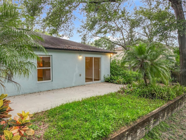 2353 Kingscrest Cir, Apopka, FL 32712 - back of property featuring stucco siding, a patio, and roof with shingles