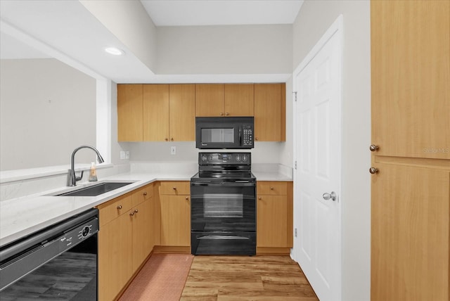 322 E Central Blvd Unit 614, Orlando, FL 32801 - kitchen with black appliances, light countertops, light wood-style floors, and recessed lighting