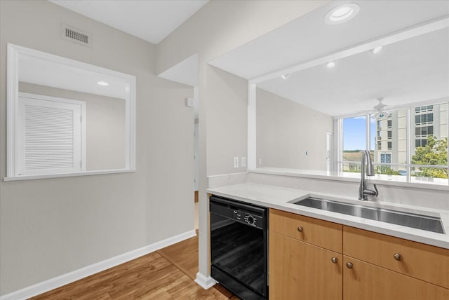 322 E Central Blvd Unit 614, Orlando, FL 32801 - kitchen featuring black dishwasher, light wood-type flooring, light countertops, a ceiling fan, and recessed lighting