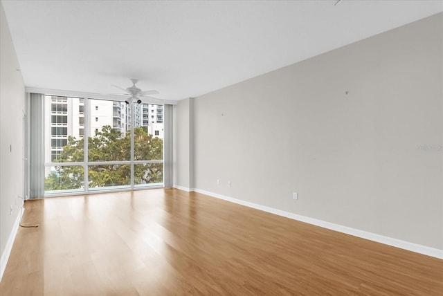 322 E Central Blvd Unit 614, Orlando, FL 32801 - empty room with floor to ceiling windows, wood finished floors, and ceiling fan