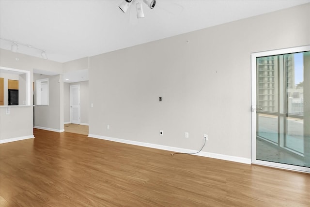 322 E Central Blvd Unit 614, Orlando, FL 32801 - unfurnished living room with light wood finished floors, a ceiling fan, and rail lighting