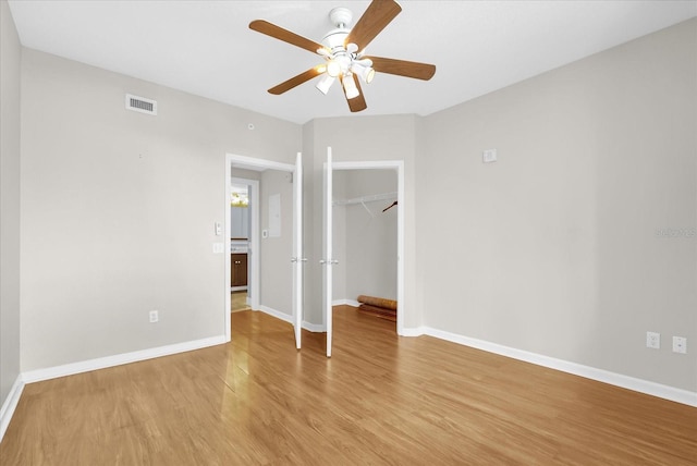 322 E Central Blvd Unit 614, Orlando, FL 32801 - unfurnished bedroom featuring light wood-style floors, a closet, and ceiling fan
