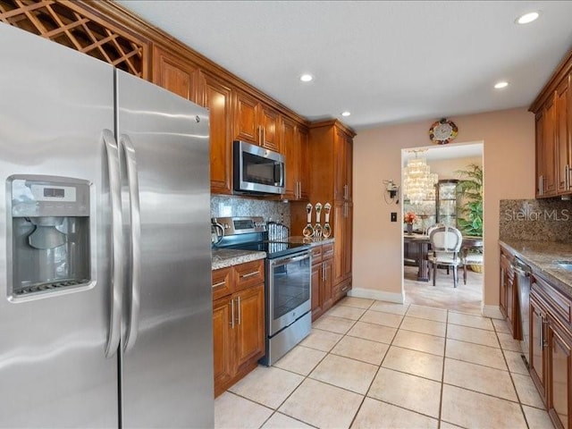 961 SW 98th Ave, Pembroke Pines, FL 33025 - kitchen featuring appliances with stainless steel finishes, brown cabinets, backsplash, and recessed lighting