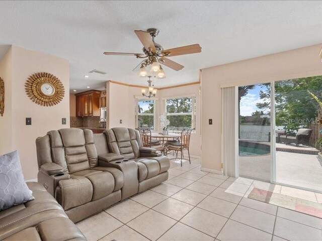 961 SW 98th Ave, Pembroke Pines, FL 33025 - living area featuring light tile patterned flooring, a ceiling fan, a chandelier, and recessed lighting