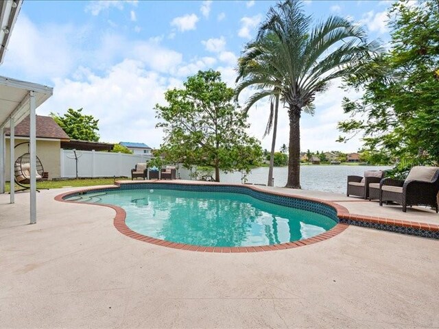 961 SW 98th Ave, Pembroke Pines, FL 33025 - view of swimming pool with a patio area and a water view