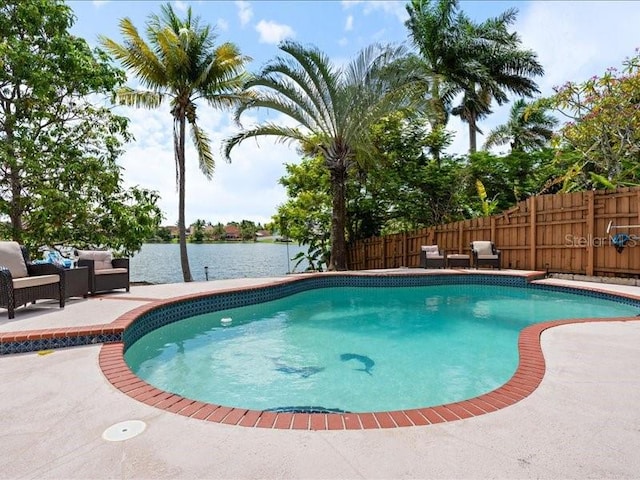 961 SW 98th Ave, Pembroke Pines, FL 33025 - view of swimming pool featuring a patio, a fenced backyard, outdoor lounge area, and a water view