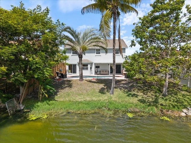 961 SW 98th Ave, Pembroke Pines, FL 33025 - rear view of house featuring an outdoor pool, stucco siding, and a water view
