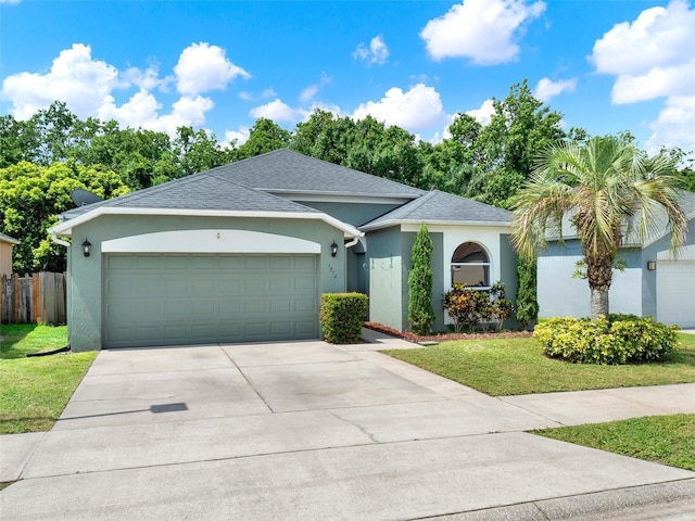 1712 Riveredge Rd, Oviedo, FL 32766 - ranch-style house featuring stucco siding, a garage, concrete driveway, and a shingled roof