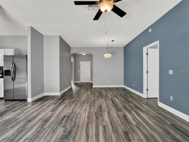 1712 Riveredge Rd, Oviedo, FL 32766 - unfurnished living room featuring ceiling fan, arched walkways, dark wood-type flooring, and a textured ceiling