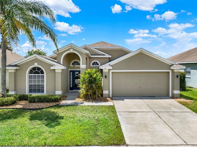 211 Tavestock Loop, Winter Springs, FL 32708 - view of front facade with stucco siding, concrete driveway, an attached garage, and a front yard