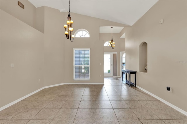 211 Tavestock Loop, Winter Springs, FL 32708 - entrance foyer with a chandelier, light tile patterned floors, high vaulted ceiling, and arched walkways