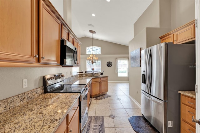 211 Tavestock Loop, Winter Springs, FL 32708 - kitchen featuring stainless steel appliances, vaulted ceiling, light tile patterned flooring, a chandelier, and light stone countertops