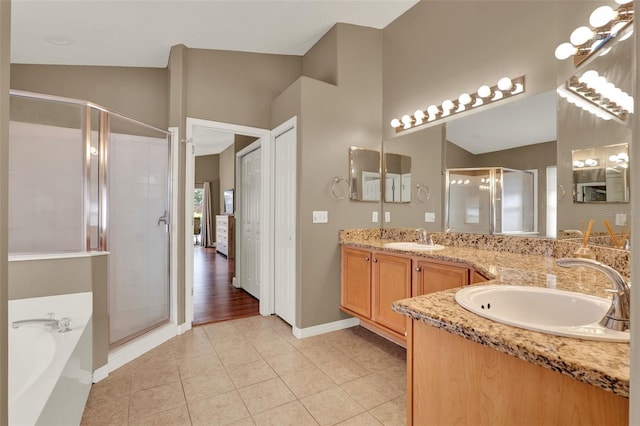 211 Tavestock Loop, Winter Springs, FL 32708 - full bathroom featuring double vanity, a shower stall, a bath, and tile patterned floors